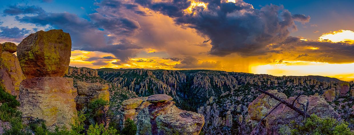 A colorful monsoon storm dumps rain over the hoodoos in the Chiracahua Mountains, near Willcox, Arizona.