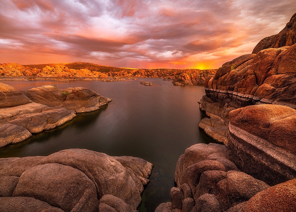 A late-summer storm fills the sky over Prescott’s Watson Lake with the colors of sunset.