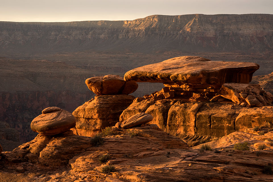 Below the Canyon’s North Rim, the Esplanade’s  expanse of red sandstone cradles a variety of hoodoos and other rock formations. By Bill Hatcher