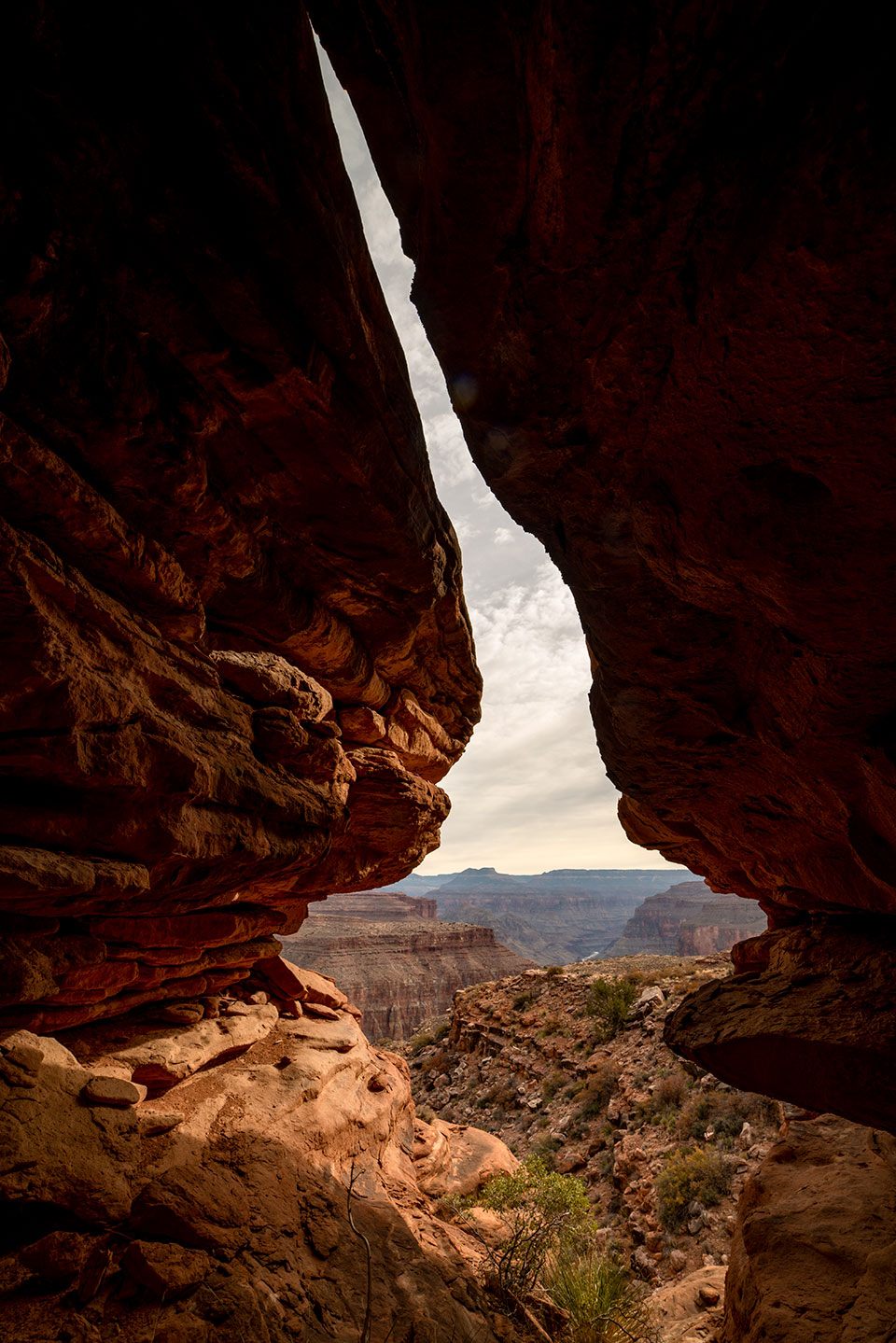 The Canyon is framed by a slot between two rock formations. By Bill Hatcher