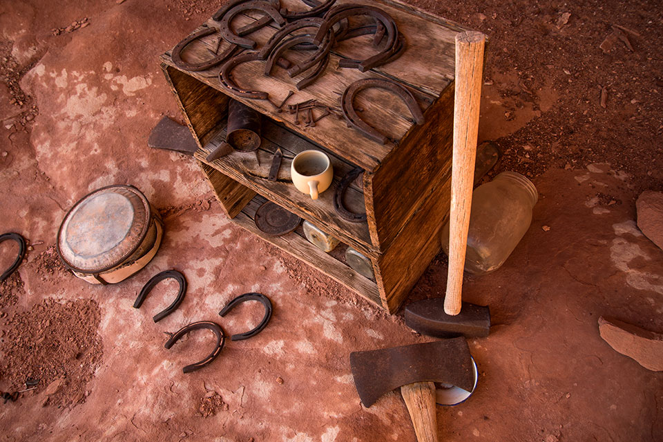 The Esplanade’s human history is evident at an old cowboy camp with horsehoes, a mug and tools. By Bill Hatcher