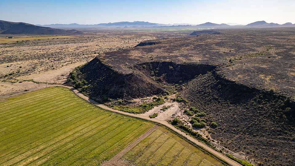 A mesa looms over farm fields at the ranch, which is one of several private properties within the proposed monument’s boundaries. By David Wallace