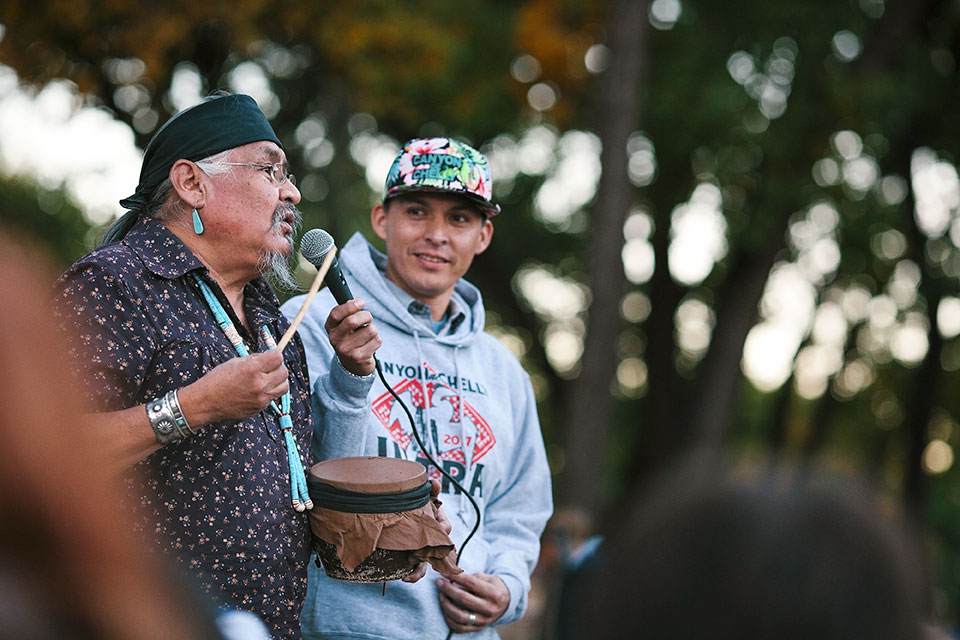 Navajo elder William Yazzie (left) and race organizer Shaun Martin greet runners and share stories the night before the race. | Caitlin O’Hara