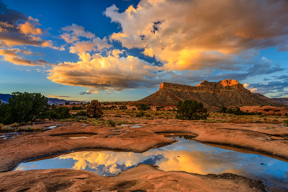 Pockets of rainwater near Toroweap Overlook, a remote destination on the Grand Canyon’s North Rim, mirror a colorful sky. Toroweap is known for its sheer 3,000-foot drop to the Colorado River, which is among the plateau’s lowest points. By Ralph Lee Hopkins