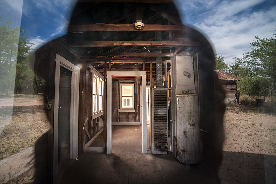 The photographer’s reflection frames a view through a window of one of Fairbank’s buildings. By Eirini Pajak