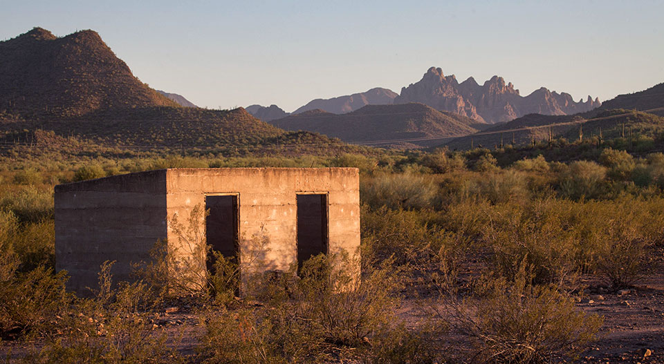 Sasco’s jail is one of the ghost town’s many surviving structures. In the background is Ragged Top, a defining feature of nearby Ironwood Forest National Monument. By Eirini Pajak