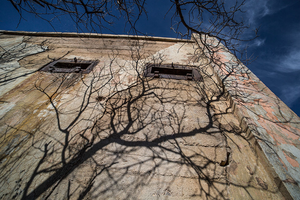 Shadows creep up the side of Courtland’s concrete jail. By Eirini Pajak