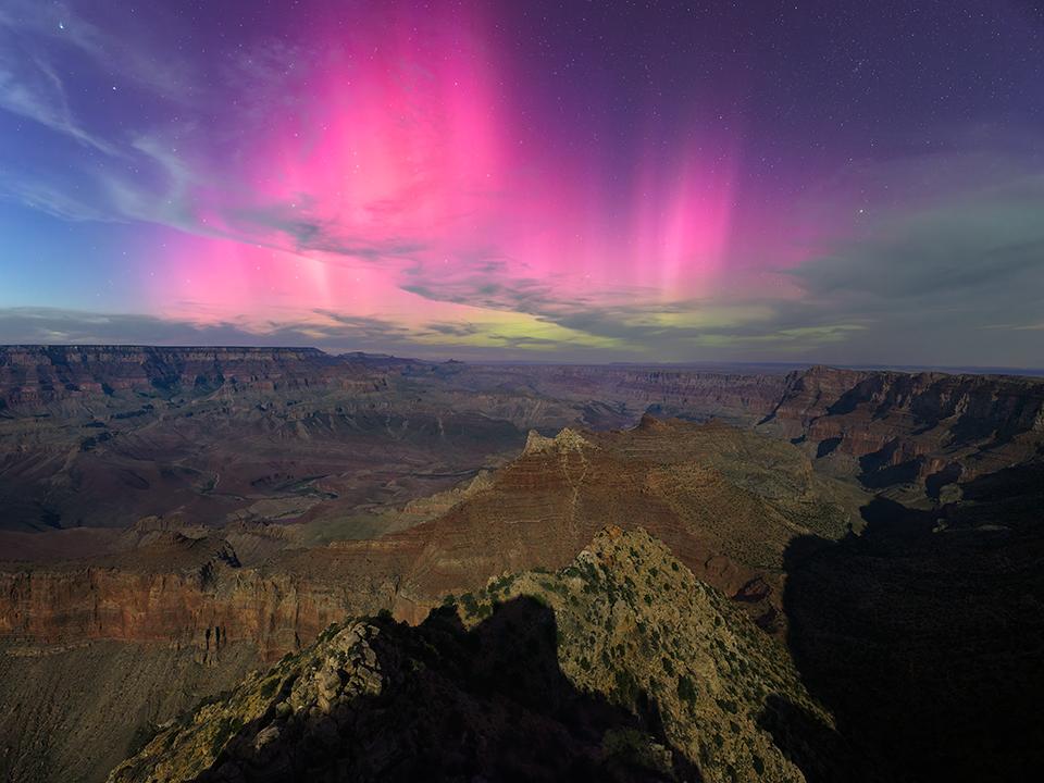 In a view from the South Rim, a purple aurora mingles with wispy clouds above the moonlit Canyon. Named an International Dark Sky Park in 2019, Grand Canyon National Park is known for its nighttime beauty. | Adam Schallau