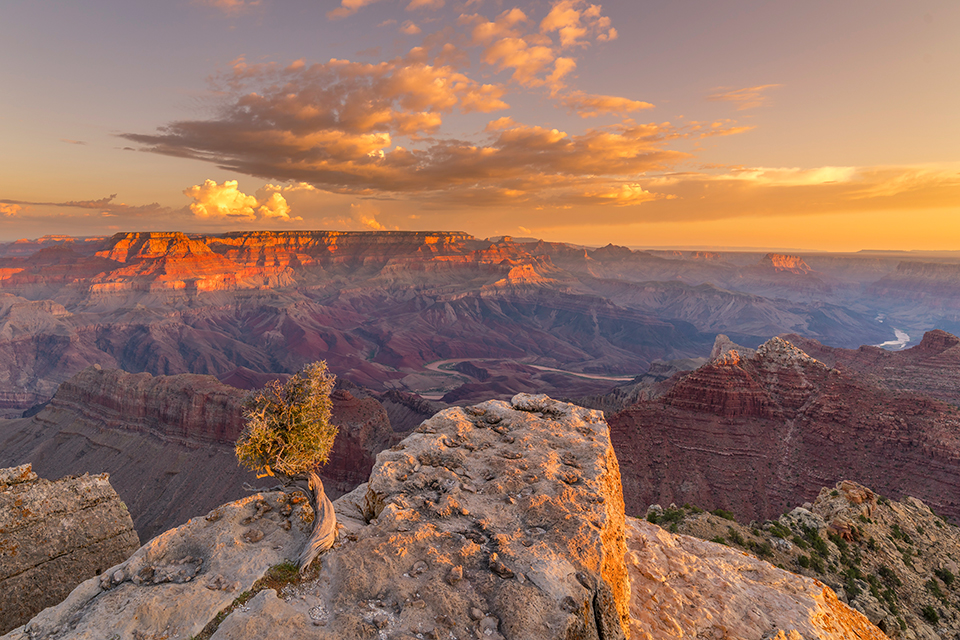 At sunrise, monsoon storm clouds linger over the Canyon, as seen from the South Rim’s Lipan Point. Visible in the distance is the Unkar Delta, a large patch of sandy soil at a bend in the river; more than 50 Ancestral Puebloan archaeological sites are found there.