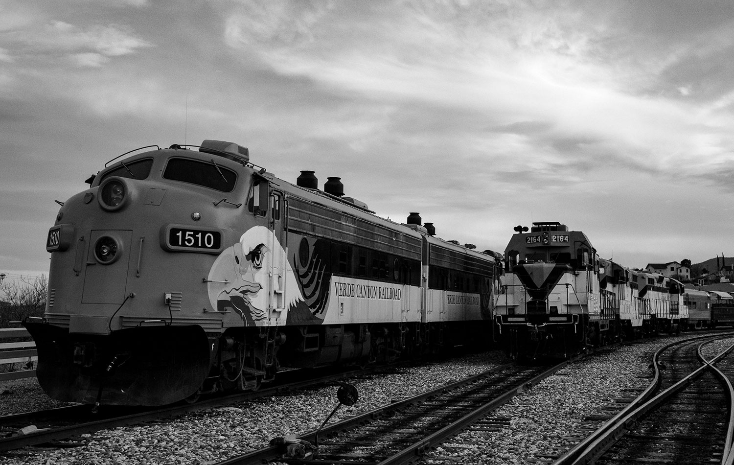 Black and White Wednesday: Two diesel engines rest under cloudy skies at the Verde Canyon Railroad station. By Kirk Higgins