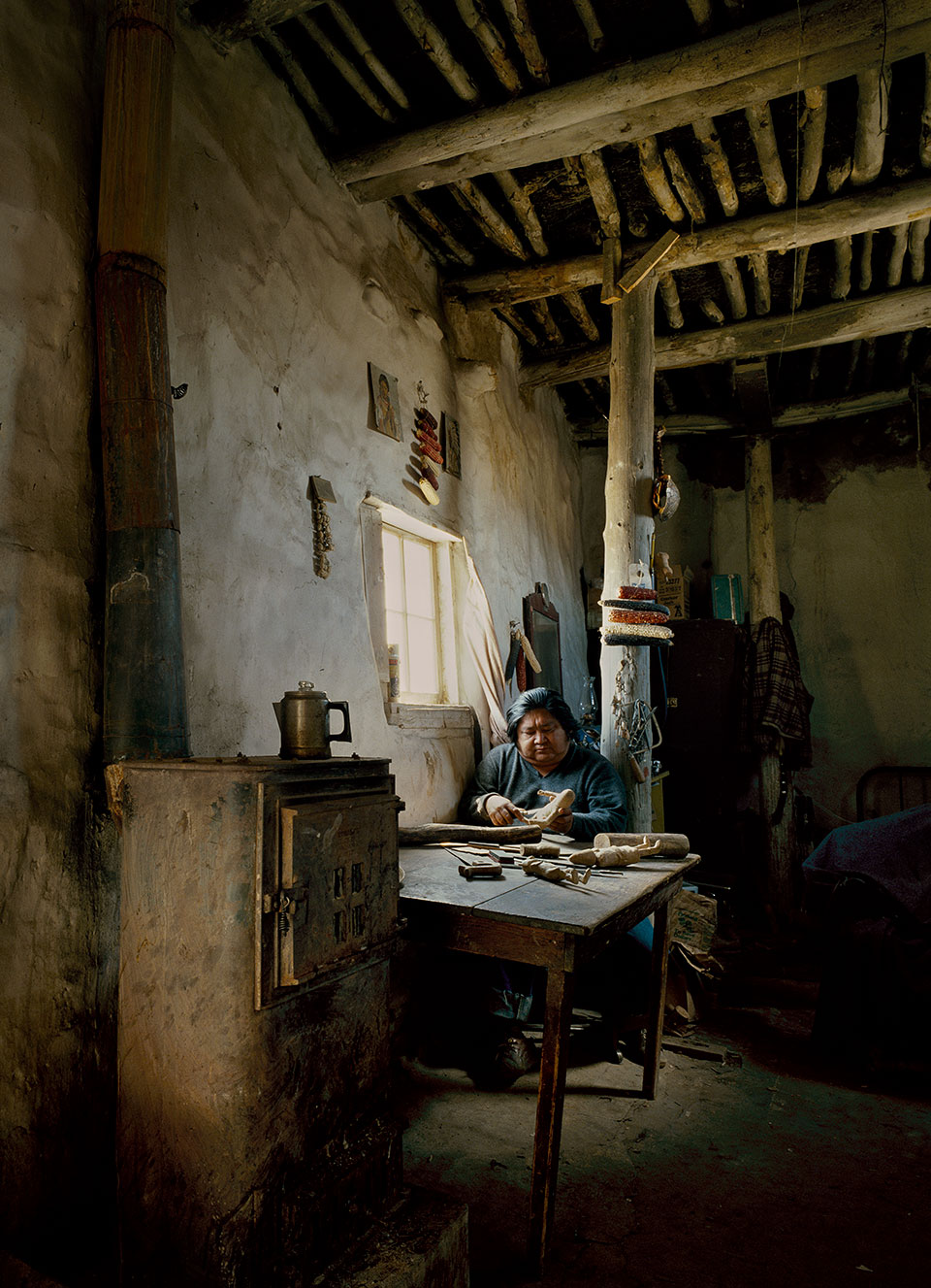 The morning sun provides light and warmth for Jerry Lacapa as he carves kachinas in his home in the Hopi Tribe’s Walpi village. This photo was paired with an Ekkehart Malotki piece on the Hopi writing system.