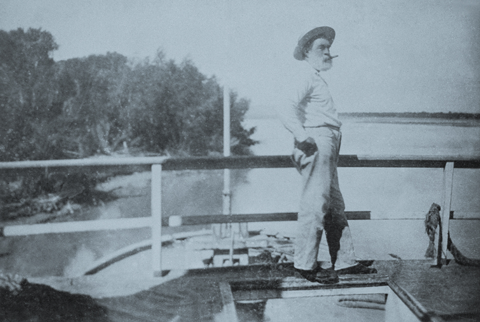 Captain Isaac Polhamus pilots a steamboat on the river around 1890. A New York native and son of a Hudson River boat captain, Polhamus arrived in Yuma County in 1856 and helmed the Colorado, the Mojave and other boats during a river career that spanned half a century. | THE HUNTINGTON LIBRARY