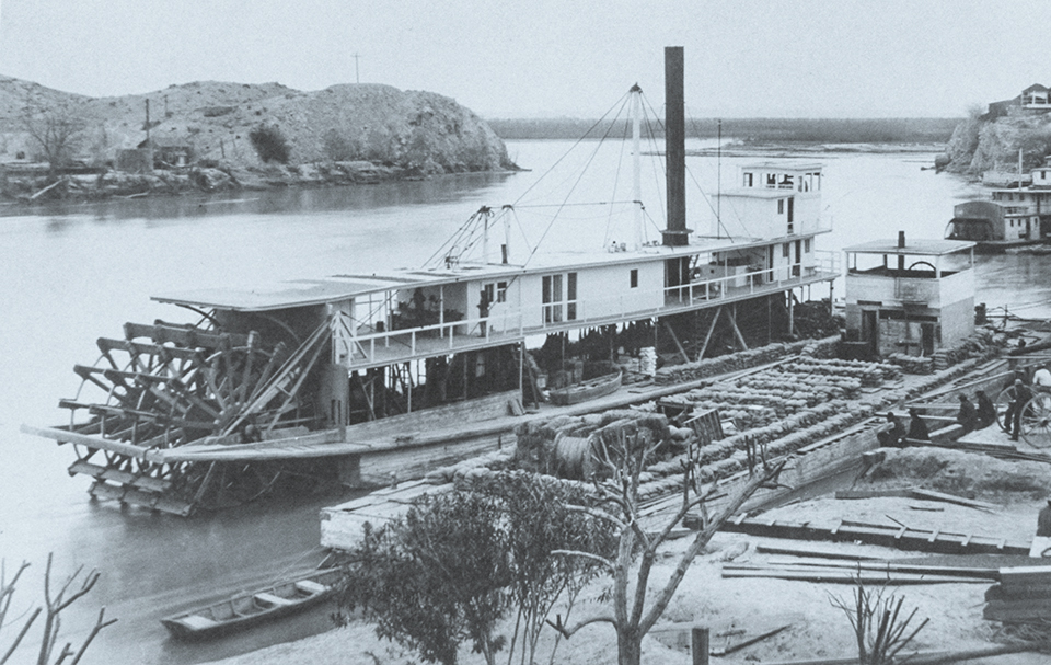 The 135-foot Cochan, the last stern-wheel steamboat built for the Colorado Steam Navigation Co., ran the river from 1900 to 1909. Another steamer, the Searchlight, is visible at far right. | THE HUNTINGTON LIBRARY