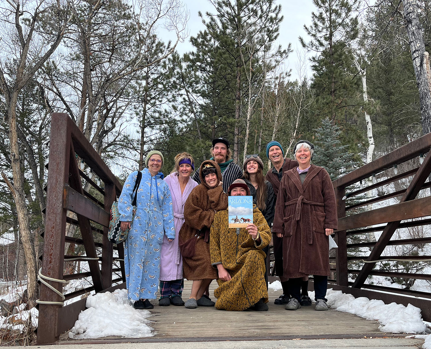 Global Snapshot at the Mt. Princeton Ht Springs Resort of 8 people posing with the November 2024 issue of Arizona Highways