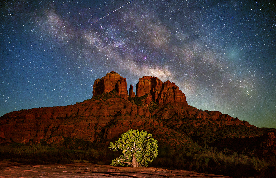 The Milky Way galaxy fills the sky over Cathedral Rock. While UFO tours are a popular activity among Sedona visitors, the kinds of orbiting objects visible from Red Rock Country can be seen from any location with dark night skies. | Theresa Rose Ditson