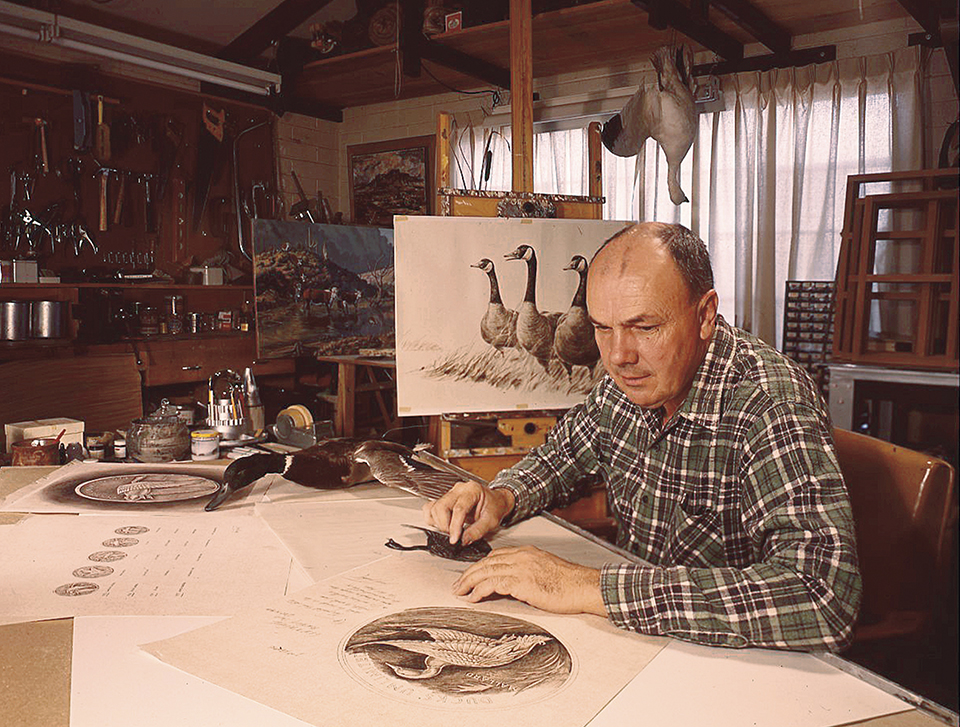 Larry Toschik at his drawing board working on an illustration of water fowl. Portrait of Carlos Elmer with camera. | COURTESY OF THE TOSCHIK FAMILY