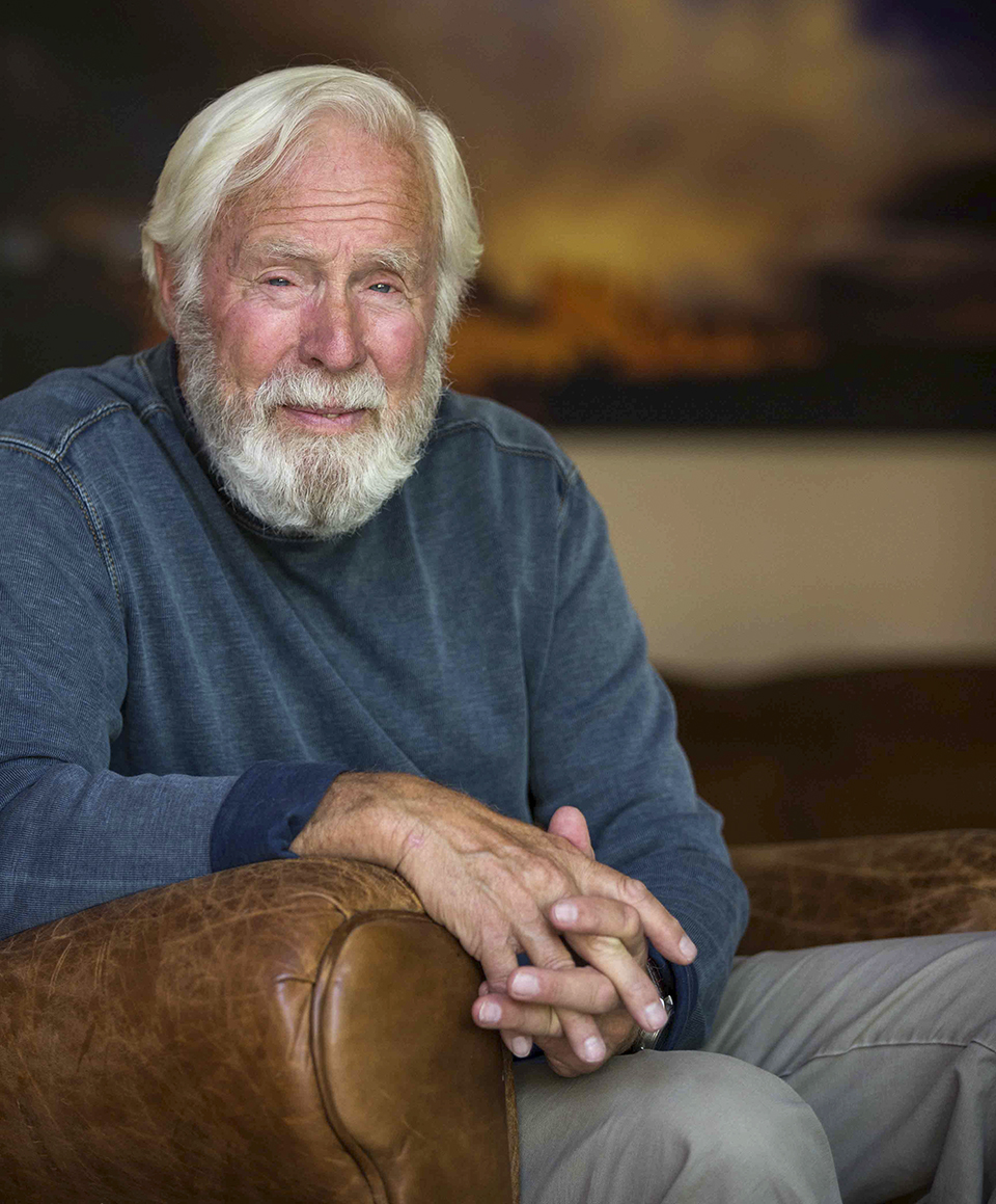 Portrait of David Muench leaning on a leather chair arm. | PAUL MARKOW  ABOVE JOEL GRIMES