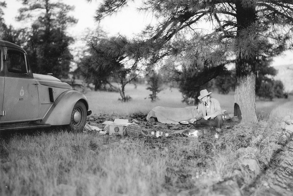 Norman G. Wallace sets up camp near his Arizona Highway Department vehicle in an undated photo. | Arizona Historical Society