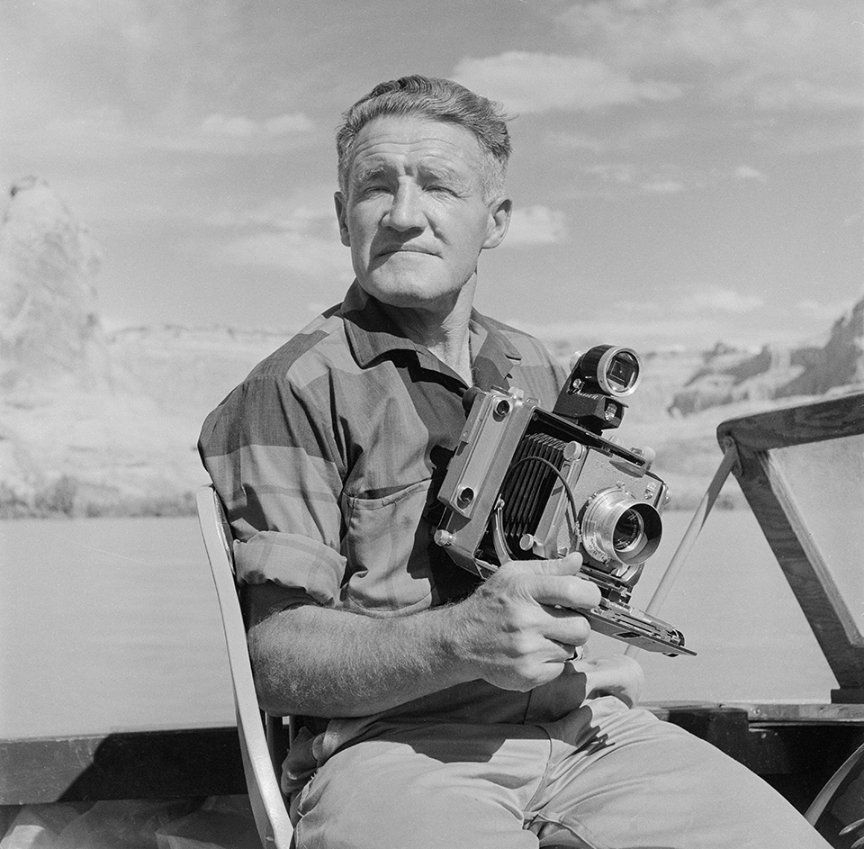 BW photo of Josef Muench posing with 4x5 camera. | NORTHERN ARIZONA UNIVERSITY CLINE LIBRARY