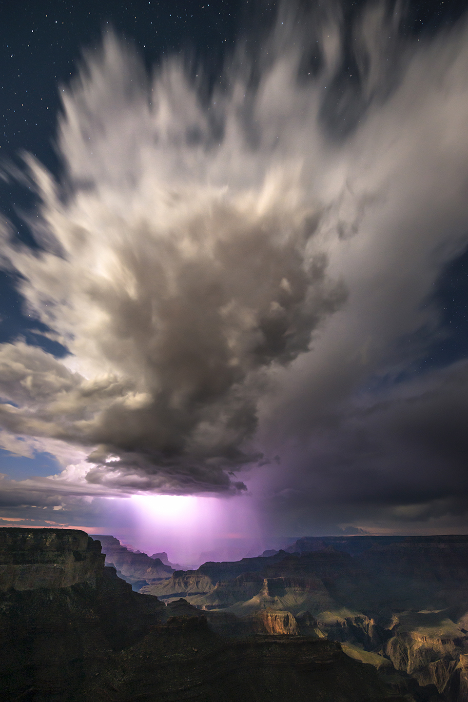 Lightning illuminates clouds during a monsoon storm at the Grand Canyon. By Adam Schallau