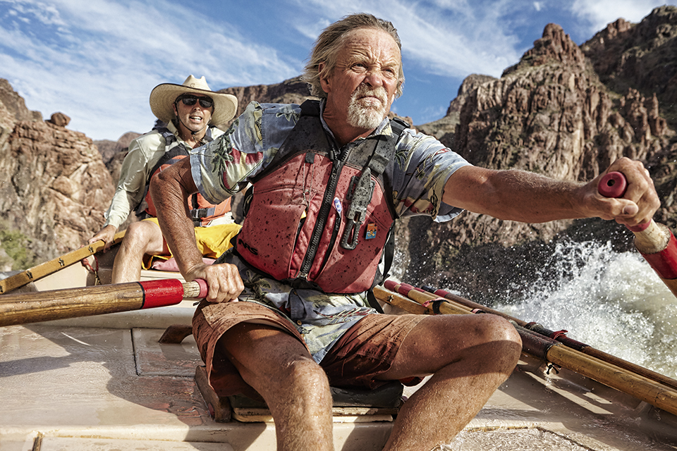 Brad Dimock, a legendary boatman, boat builder and author, concentrates on steering his boat through Colorado River rapids. By David Zickl