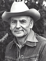 BW portrait of Allen C. Reed in denim jacket and cowboy hat. | COURTESY OF THE REED FAMILY