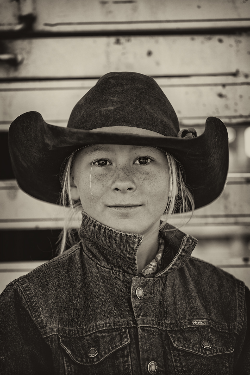 Ella Smith, her three siblings and their parents live on a Southeastern Arizona ranch. Here, Ella is pictured in front of a stock trailer during a branding at the 10 X. By Scott Baxter