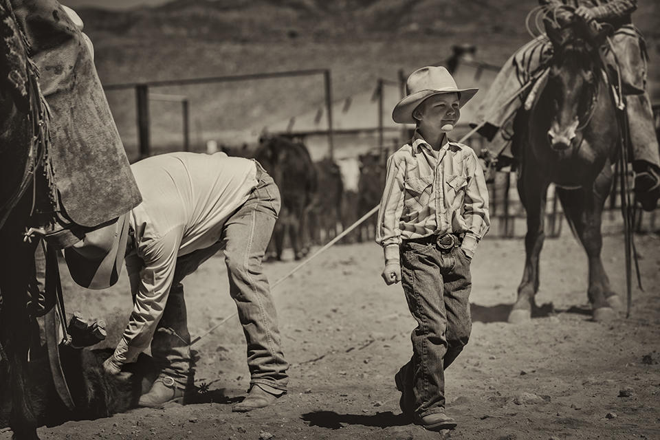 Gideon Smith, Ella’s younger brother, works in the branding corral under the tutelage of Ed Ashurst.  By Scott Baxter