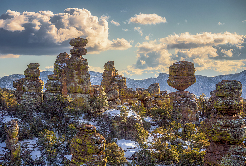 Light snow adorns the hoodoos of Southeastern Arizona’s Chiricahua National Monument. These hoodoos formed over tens of thousands of years via frost wedging, which involves water seeping into cracks in rocks and gradually widening them as it freezes and thaws. | Sean Parker