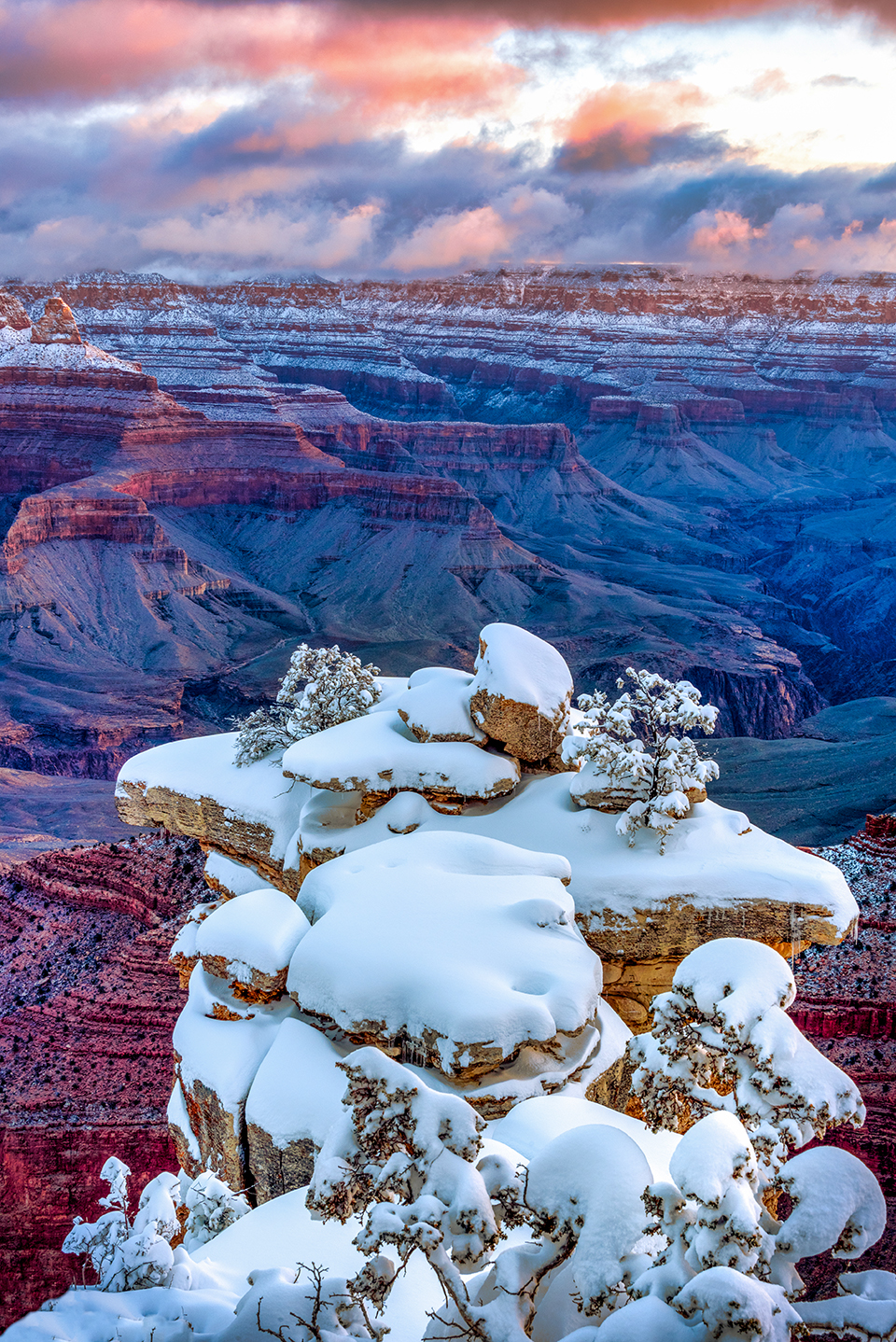 Heavy snow covers rocks on the South Rim during a winter sunrise. The South Rim averages almost 5 feet of snow per year; on the North Rim, the annual average is nearly 12 feet. | Gerry Groeber