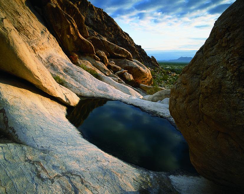 Using a mariner's astrolabe similar to the 17th-century Portuguese model at the top of the page, Kina mapped the locations of water holes, like this one in the Tinajas Altas Mountains. | GEORGE H. H. HUEY