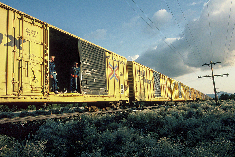 The brothers pose in an empty boxcar north of Williams. When they found themselves caught in a winter storm, they planned to sleep inside — until the train started moving.