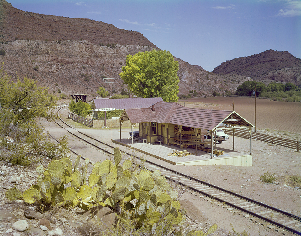 Tracks run past a modest train station in Perkinsville, a small community along the Verde River. Today, this station is abandoned but still standing, and Perkinsville serves as the turnaround point for the scenic Verde Canyon Railroad, headquartered in Clarkdale to the southeast. By Herb and Dorothy McLaughlin