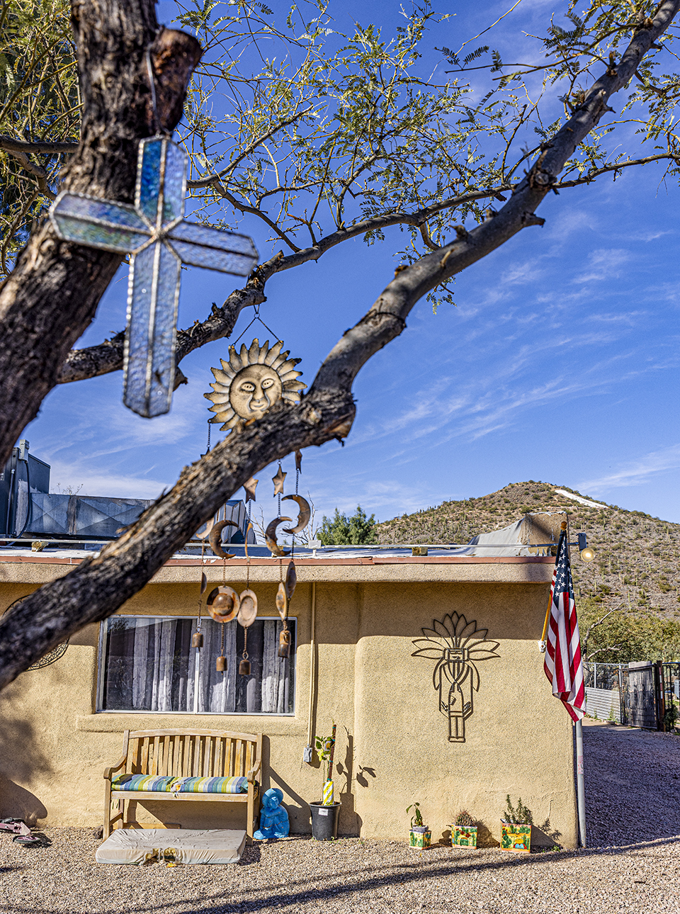 A residence in the KROEGER LANE barrio of Tucson is adorned with an array of lawn ornaments and wind chimes. By Steven Meckler