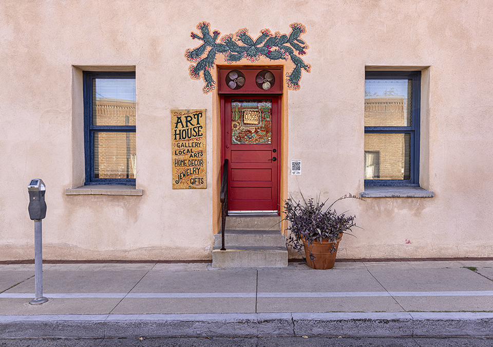 The ART HOUSE CENTRO, in the EL PRESIDIO barrio of Tucson, displays a painting of prickly pear cactus branches over the front entrance. By Steven Meckler