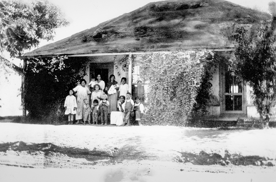 The Elias family poses for a photo in front of the family’s house, one of many built on land that Manuela Sánchez Sotelo subdivided from her homestead. | Tempe History Museum