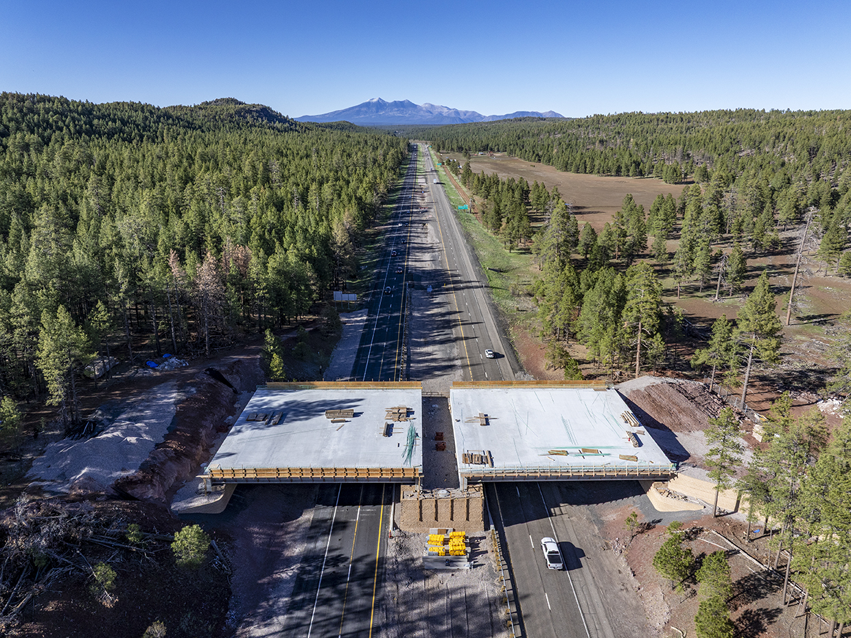 This photograph, made with a drone, shows a new wildlife bridge under construction over Interstate 17 between Munds Park and Flagstaff. | LAURENCE PARENT