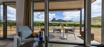 the view from inside a room at Los Milics Vineyards includes a covered patio overlooking the vineyard with a view of Mount Bruce in the distance. By Steven Meckler